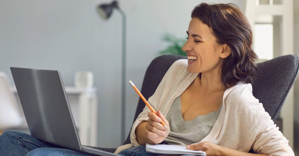 Happy Woman Taking Meeting Notes